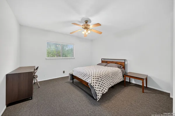 a bed room with a bed and a chandelier