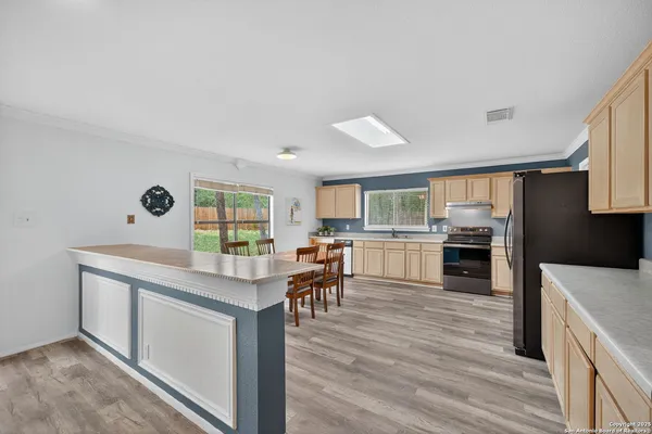 a view of kitchen with cabinets and wooden floor