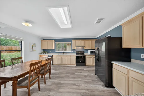 a kitchen with a table and chairs in it