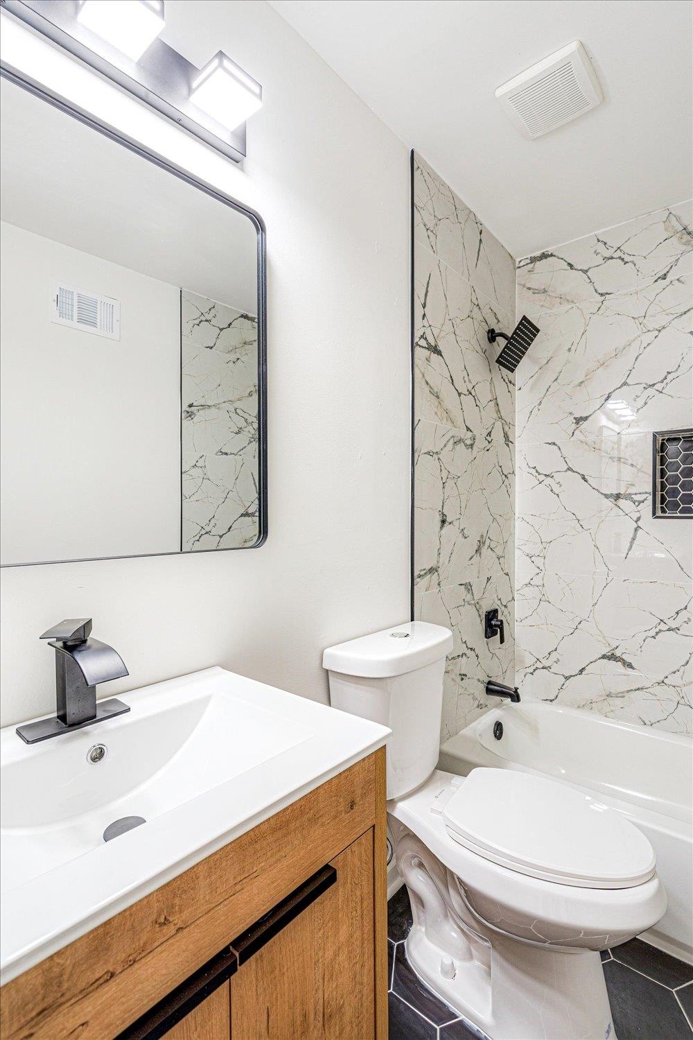 Bathroom featuring vanity and tub / shower combination
