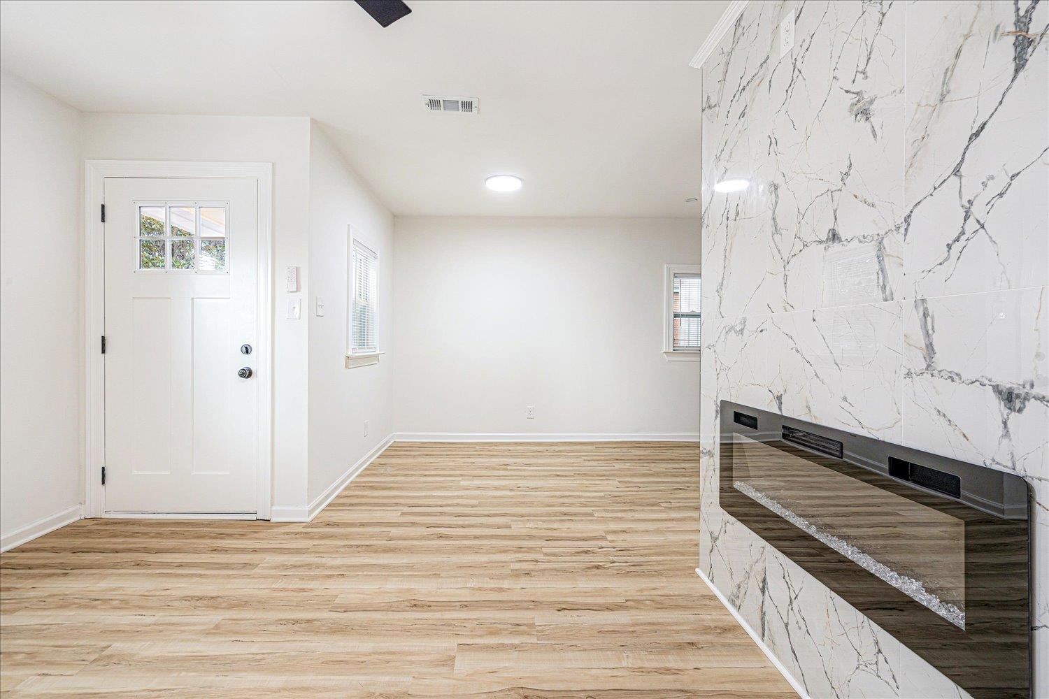 4016 Leech Road Memphis, TN 38109 - Photo 10 of 21 Entrance foyer with light wood-style flooring, an accent wall, and recessed lighting