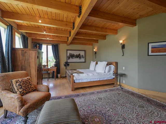 a bedroom with a bed and a couch