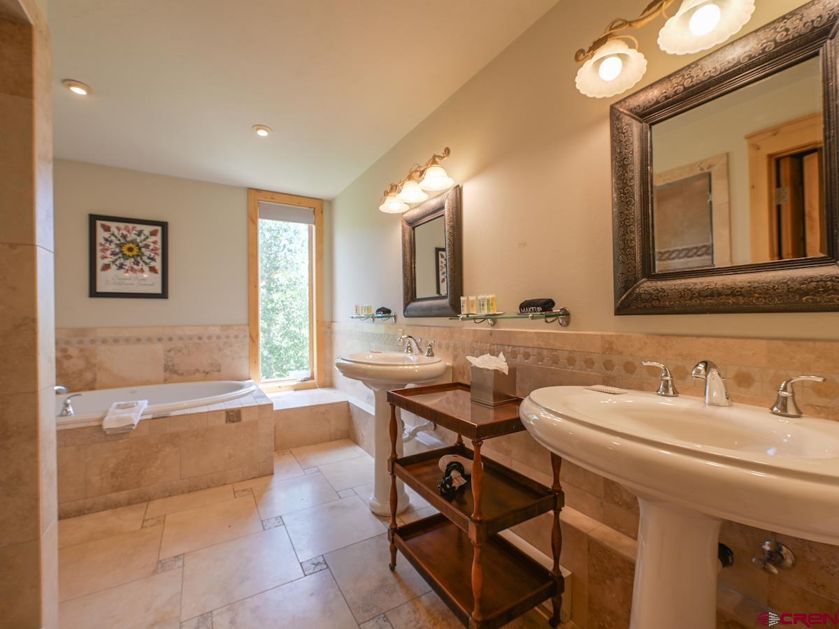 39 Whetstone Road Crested Butte, CO 81225 - Photo 23 of 35 a spacious bathroom with a sink a mirror and a bathtub