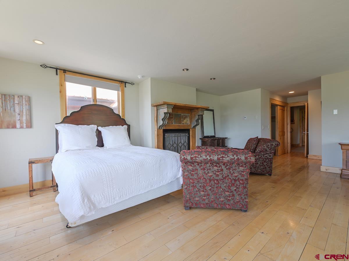 39 Whetstone Road Crested Butte, CO 81225 - Photo 24 of 35 a bedroom with a bed a couch and dresser