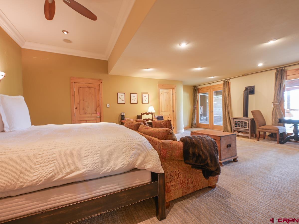 39 Whetstone Road Crested Butte, CO 81225 - Photo 25 of 35 a spacious bedroom with double bed and a large window
