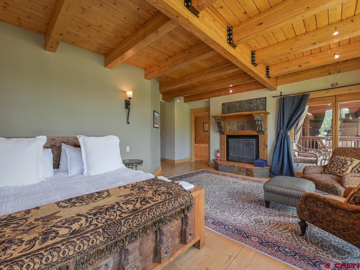 39 Whetstone Road Crested Butte, CO 81225 - Photo 30 of 35 a spacious bedroom with a large bed and a couch