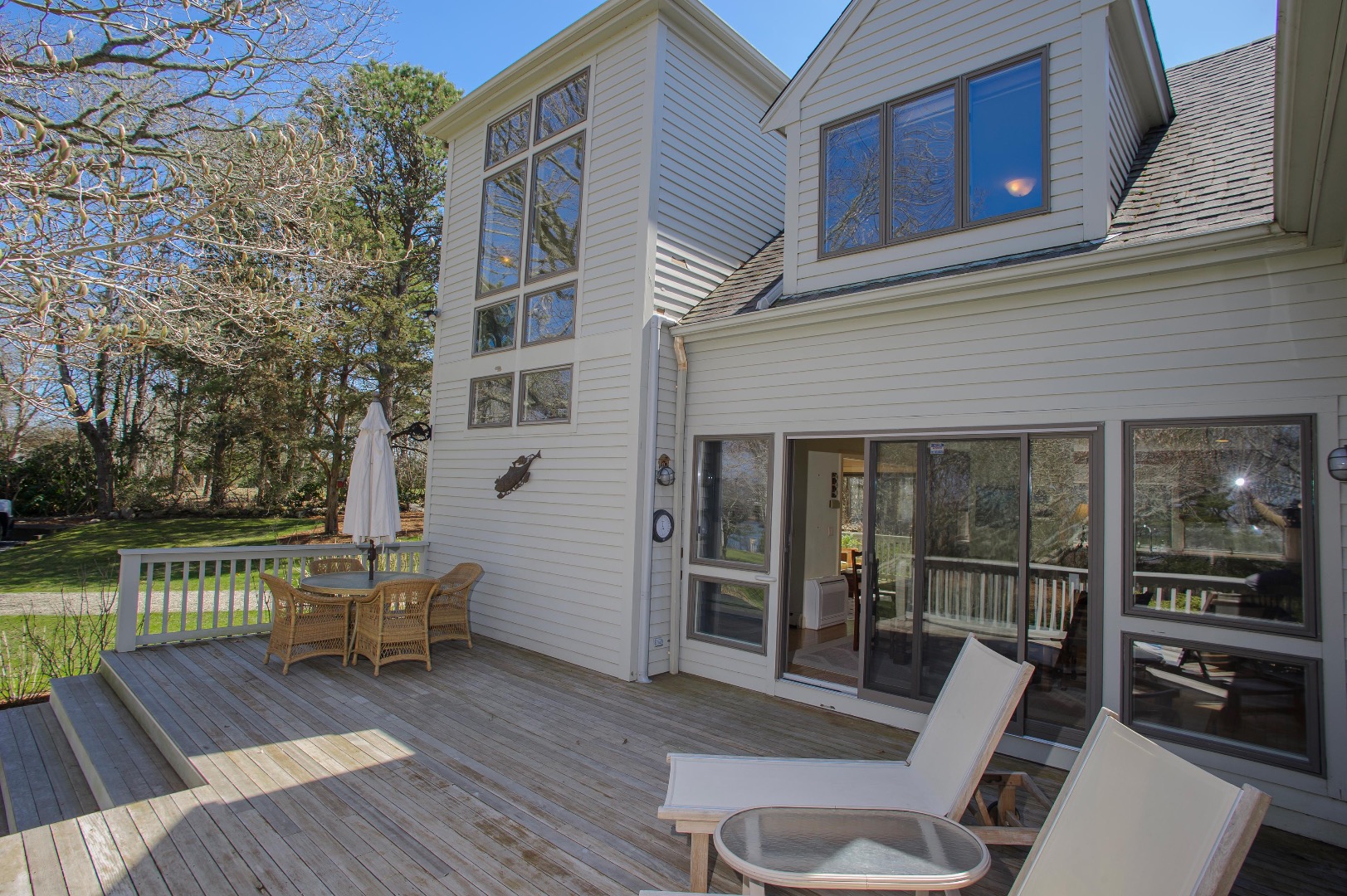 237 Lagoon Pond Road Vineyard Haven, MA 02568 - Photo 1 of 21 a view of a deck with chair and floor to ceiling window