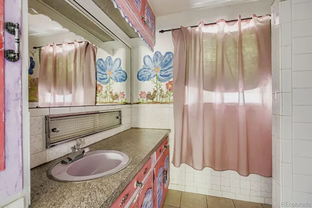 a bathroom with a sink vanity granite and a mirror