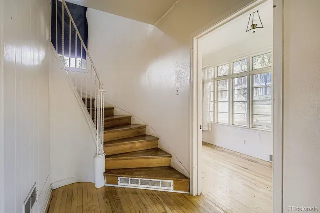 a view of entryway and hall with wooden floor