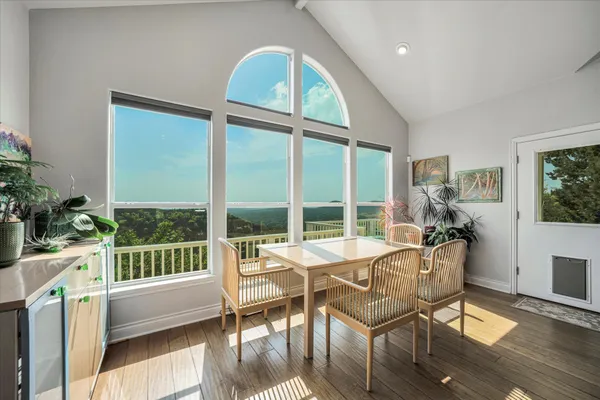 a living room with a large window and furniture