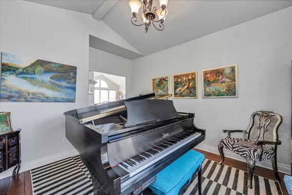 a living room with furniture and a piano