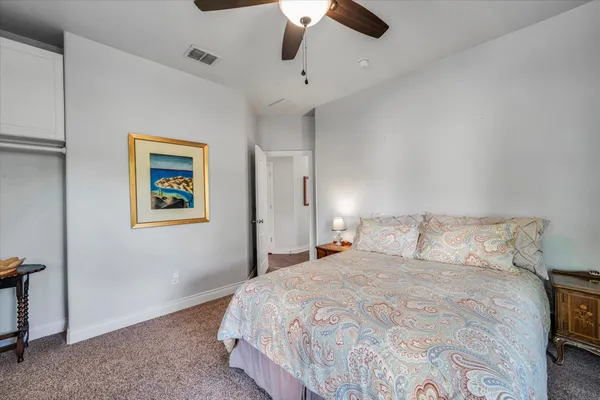 a bedroom with a bed and painting on the wall