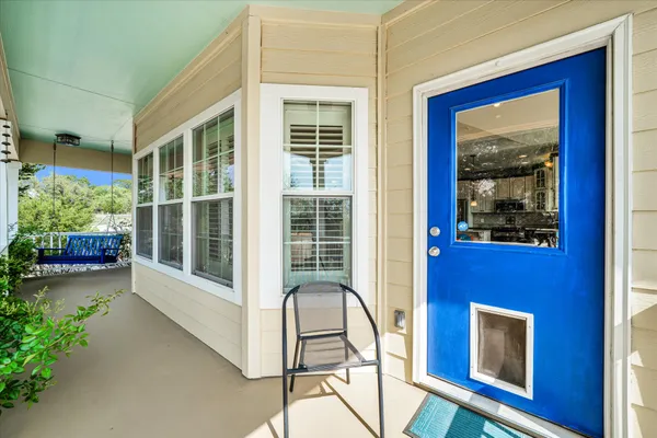 a view of a balcony with wooden floor and front door
