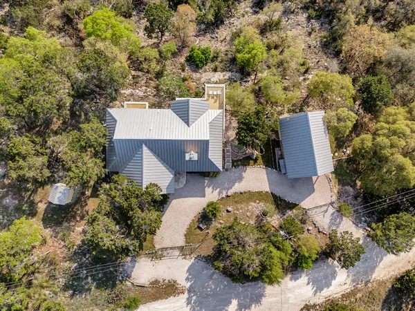 an aerial view of a house with yard and mountain view in back