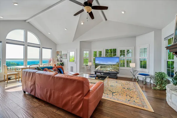 a living room with furniture fireplace and a large window