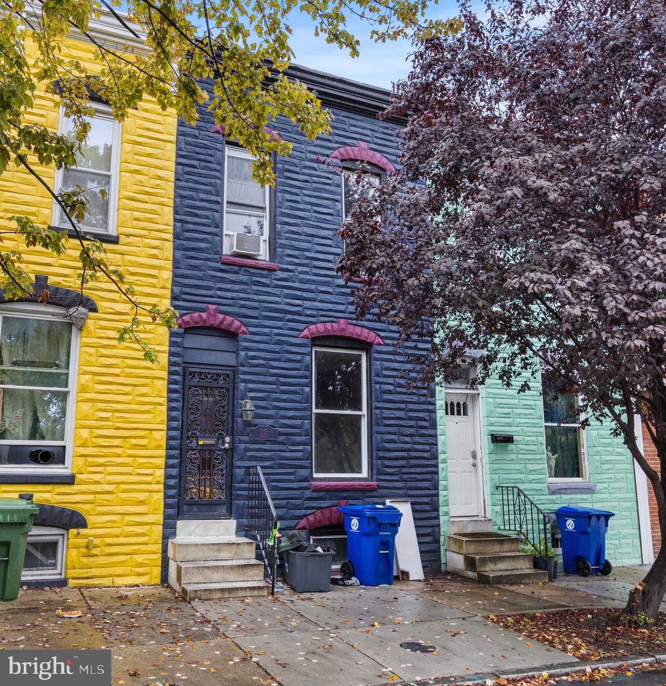 a brick house with a tree in front of it