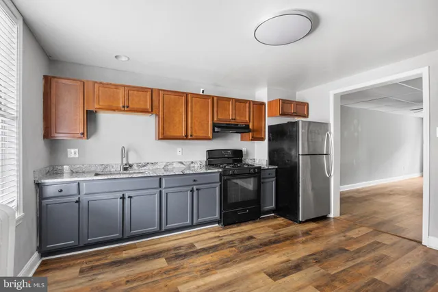 a kitchen with stainless steel appliances granite countertop a sink refrigerator and microwave