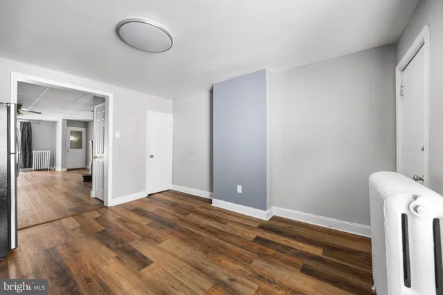 a view of a room with wooden floor and bathroom