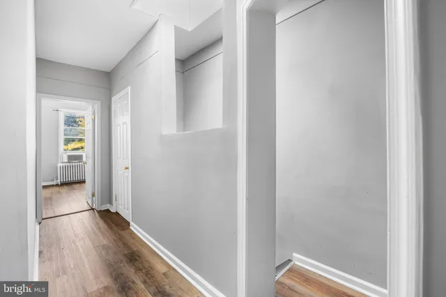 a view of a hallway with wooden floor