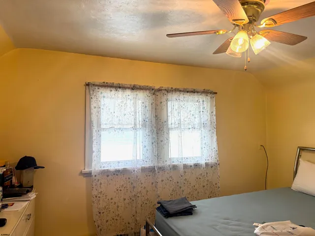 a view of a room with window and a ceiling fan