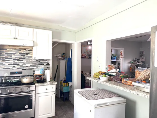a kitchen with a sink stove and refrigerator
