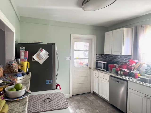 a kitchen with a sink and a stove top oven