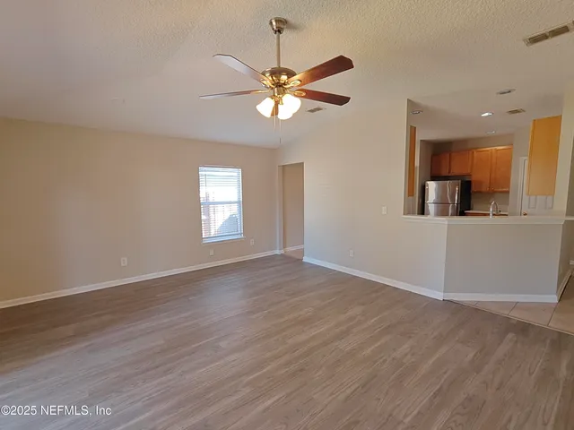 a view of a backyard with a large tree