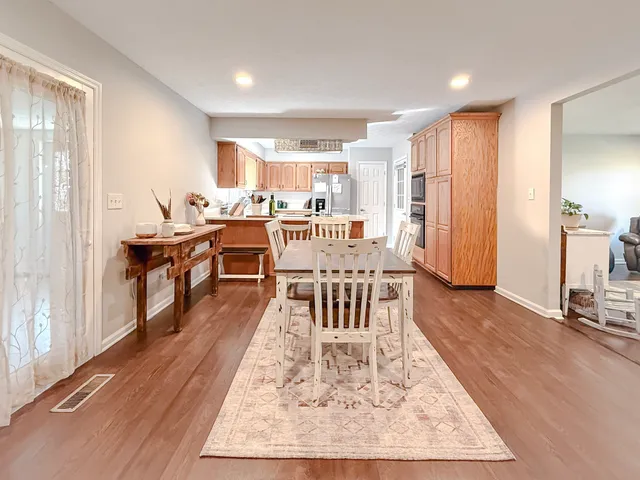 a view of a dining room with furniture window and wooden floor