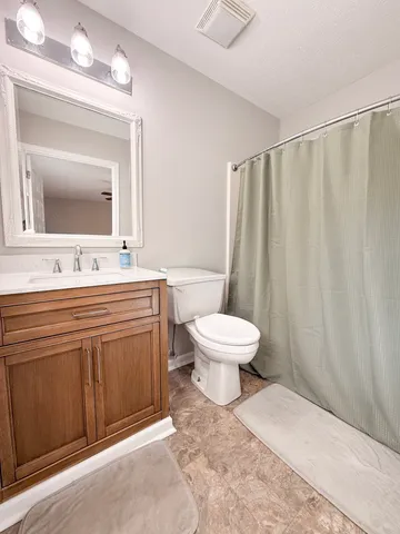 a bathroom with a toilet sink and a mirror