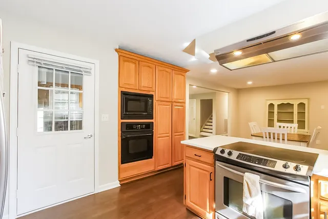a kitchen with stainless steel appliances granite countertop a stove and a refrigerator