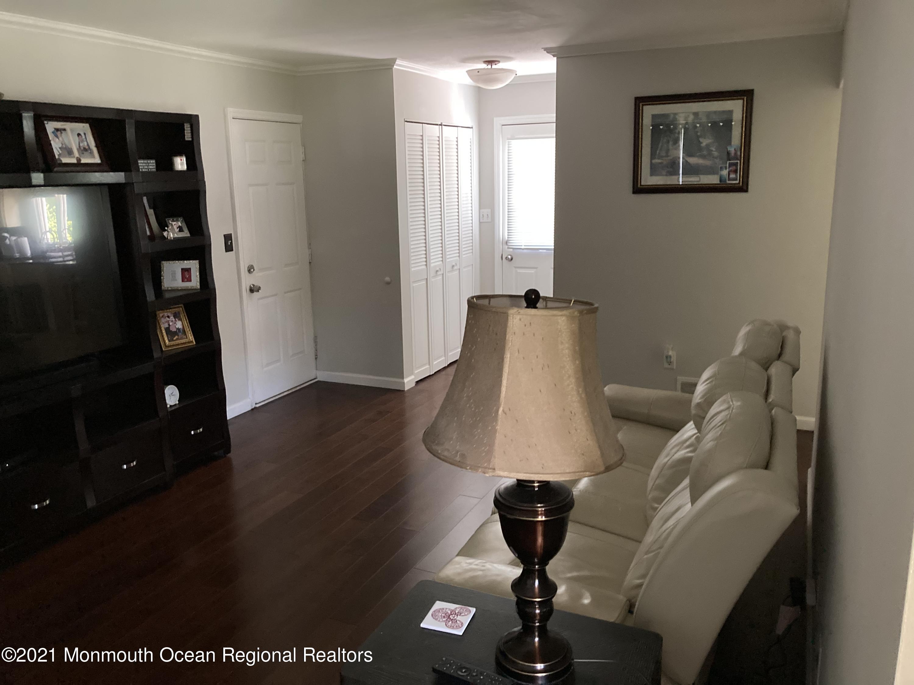 8 Tudor Road Freehold, NJ 07728 - Photo 12 of 46 a living room with furniture and a flat screen tv