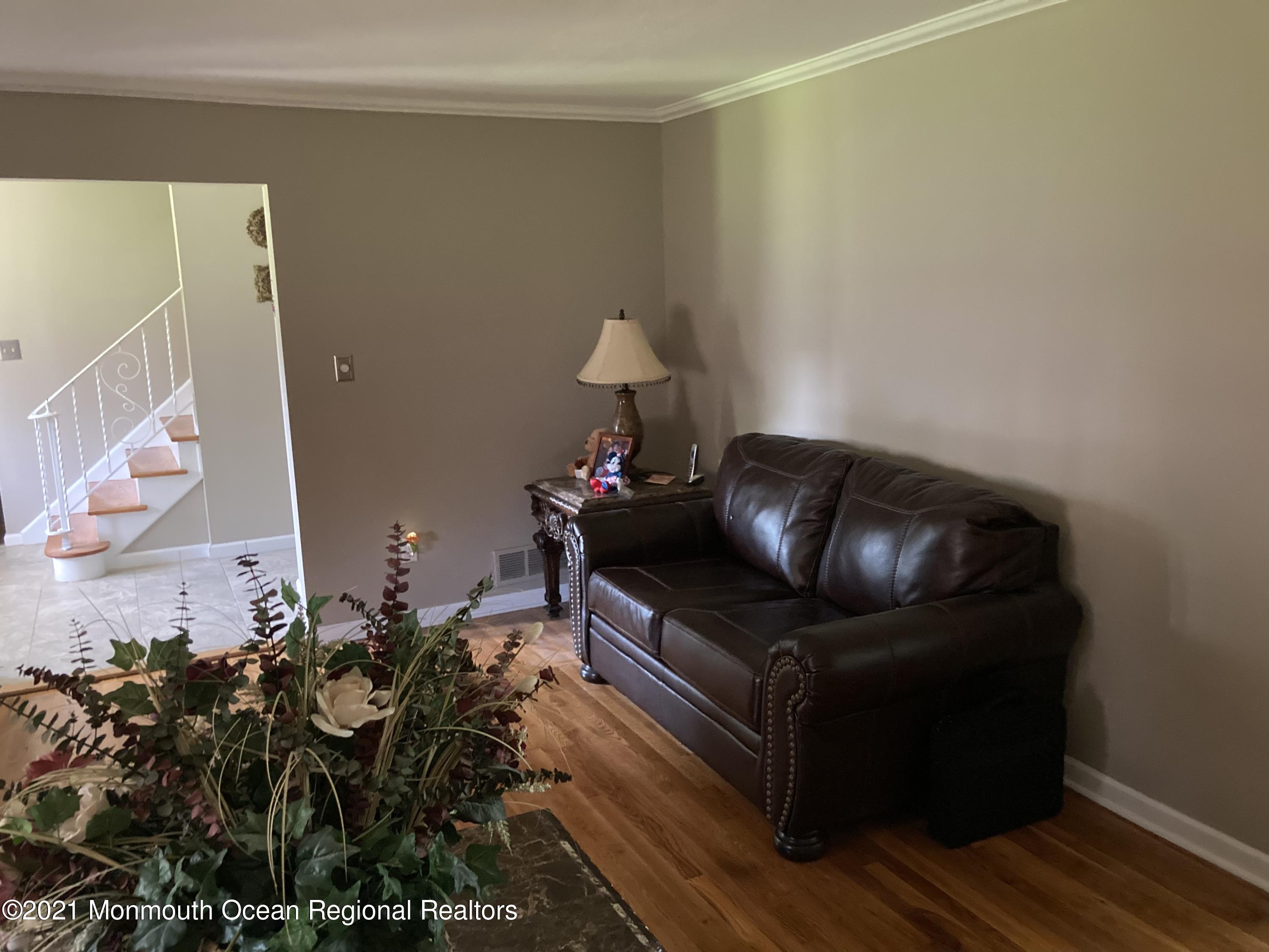 8 Tudor Road Freehold, NJ 07728 - Photo 15 of 46 a living room with furniture and wooden floor