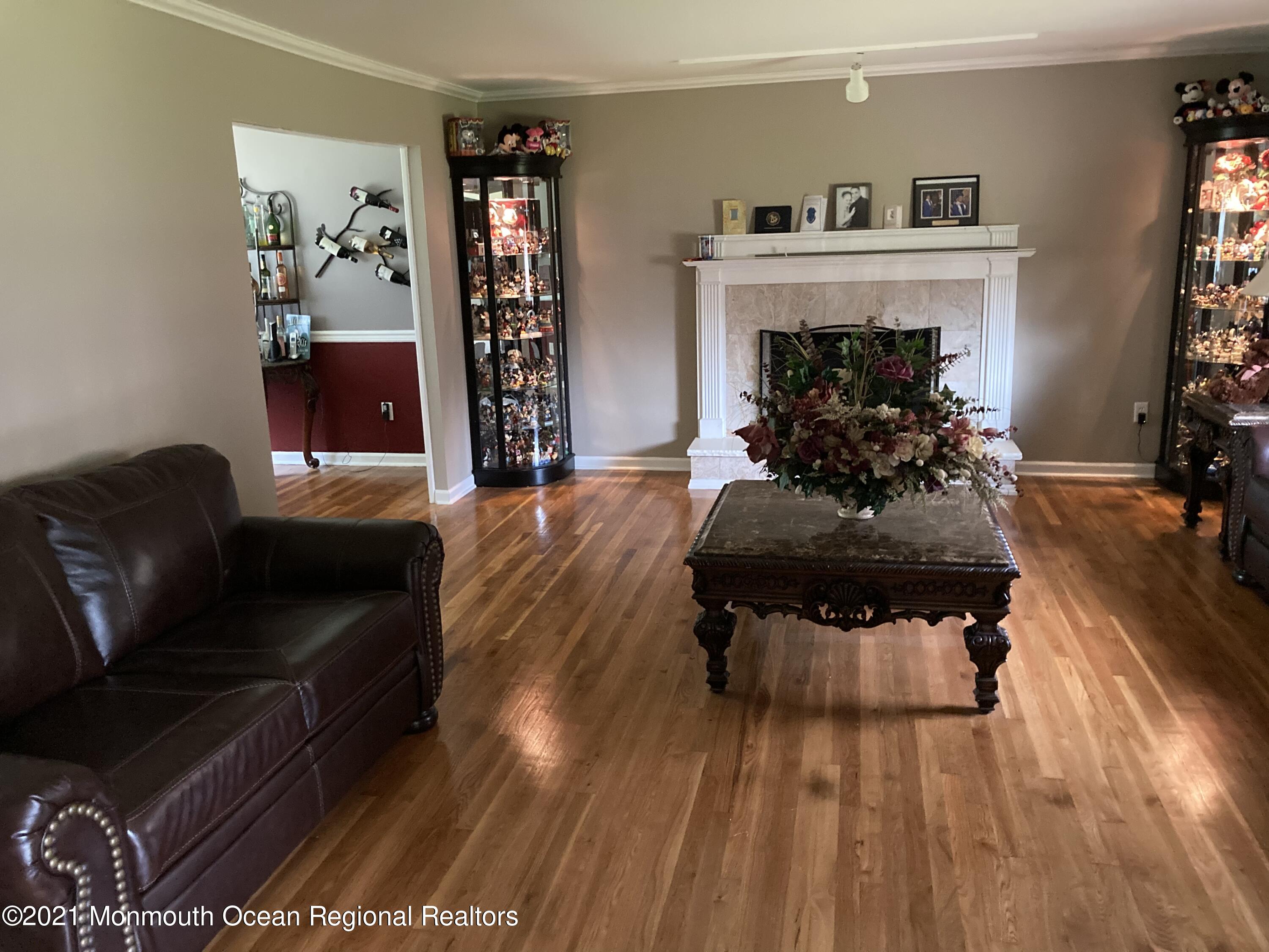 8 Tudor Road Freehold, NJ 07728 - Photo 16 of 46 a living room with furniture and a fireplace