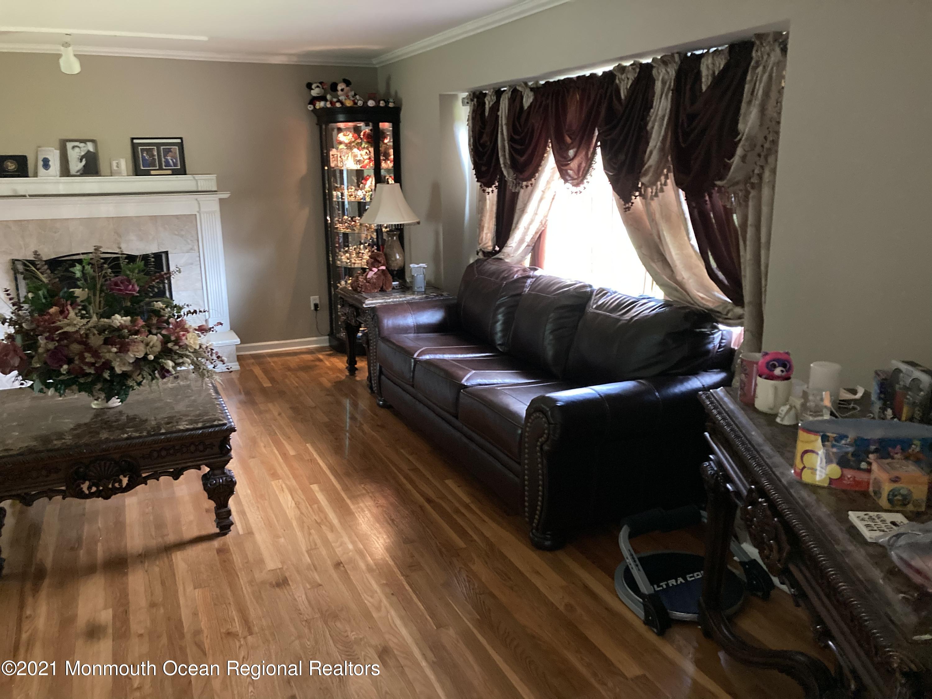 8 Tudor Road Freehold, NJ 07728 - Photo 18 of 46 a living room with furniture and a fireplace