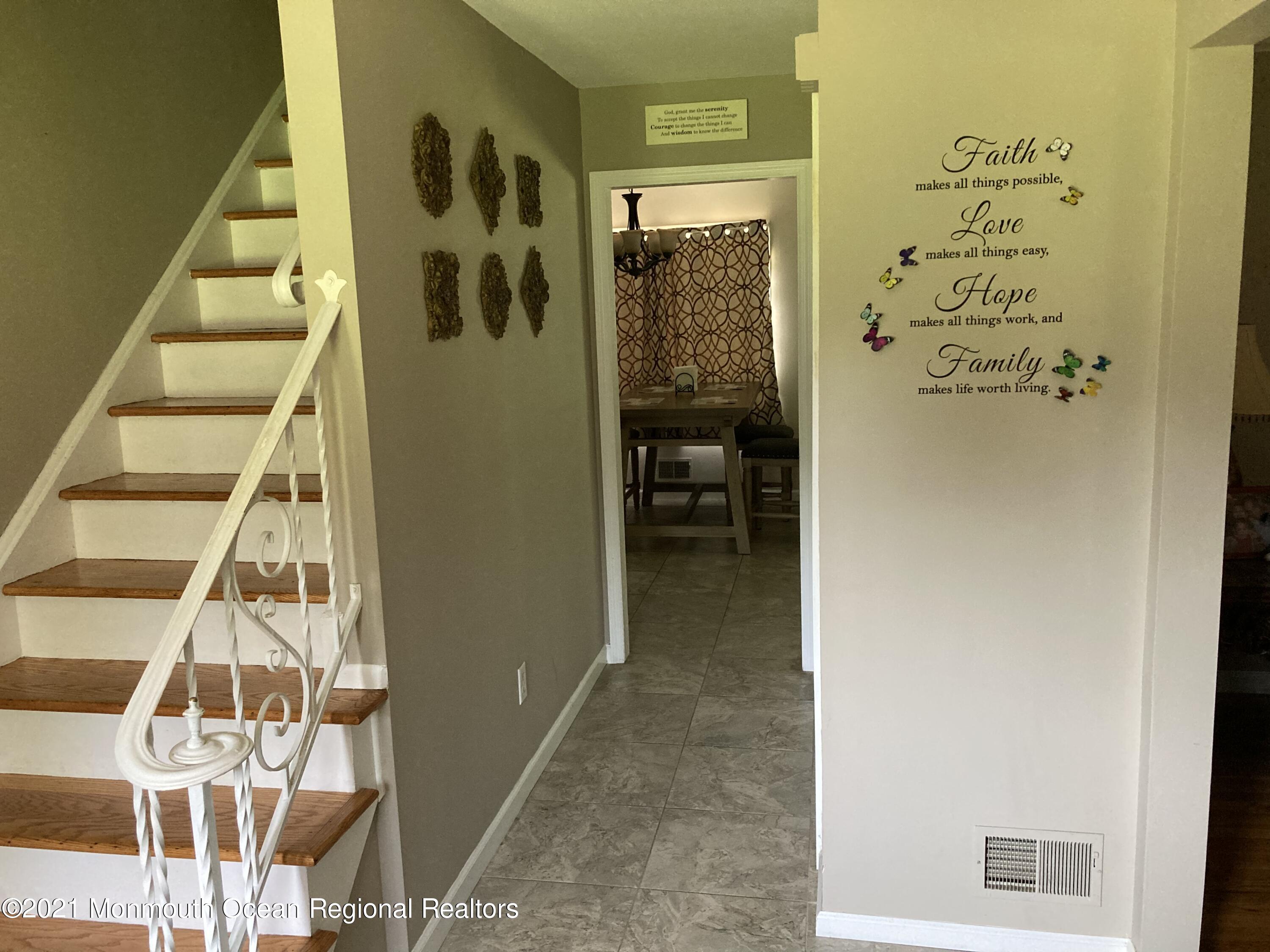 8 Tudor Road Freehold, NJ 07728 - Photo 22 of 46 a view of a hallway with wooden floor and entryway