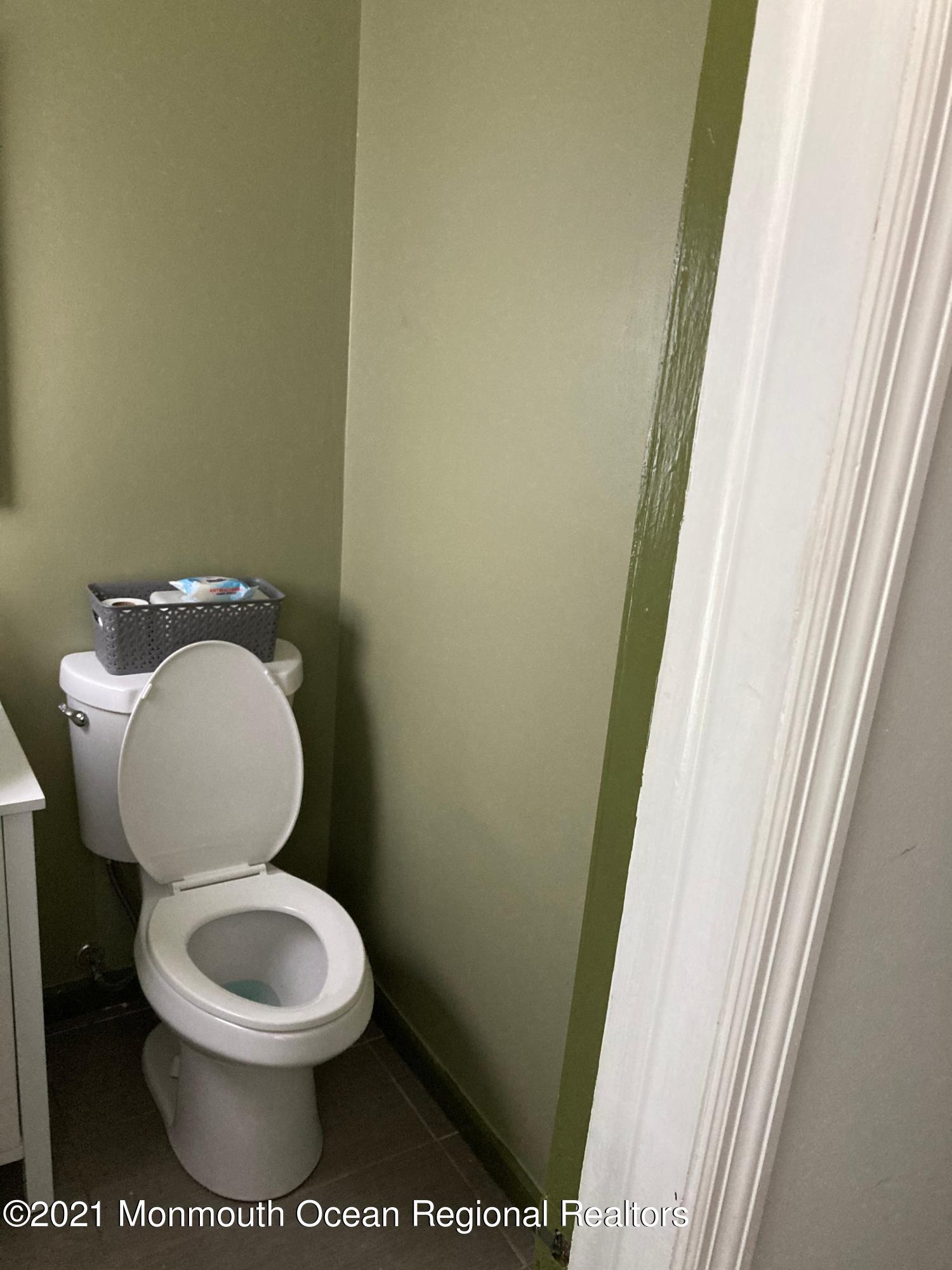 8 Tudor Road Freehold, NJ 07728 - Photo 25 of 46 a white toilet sitting next to a small sink