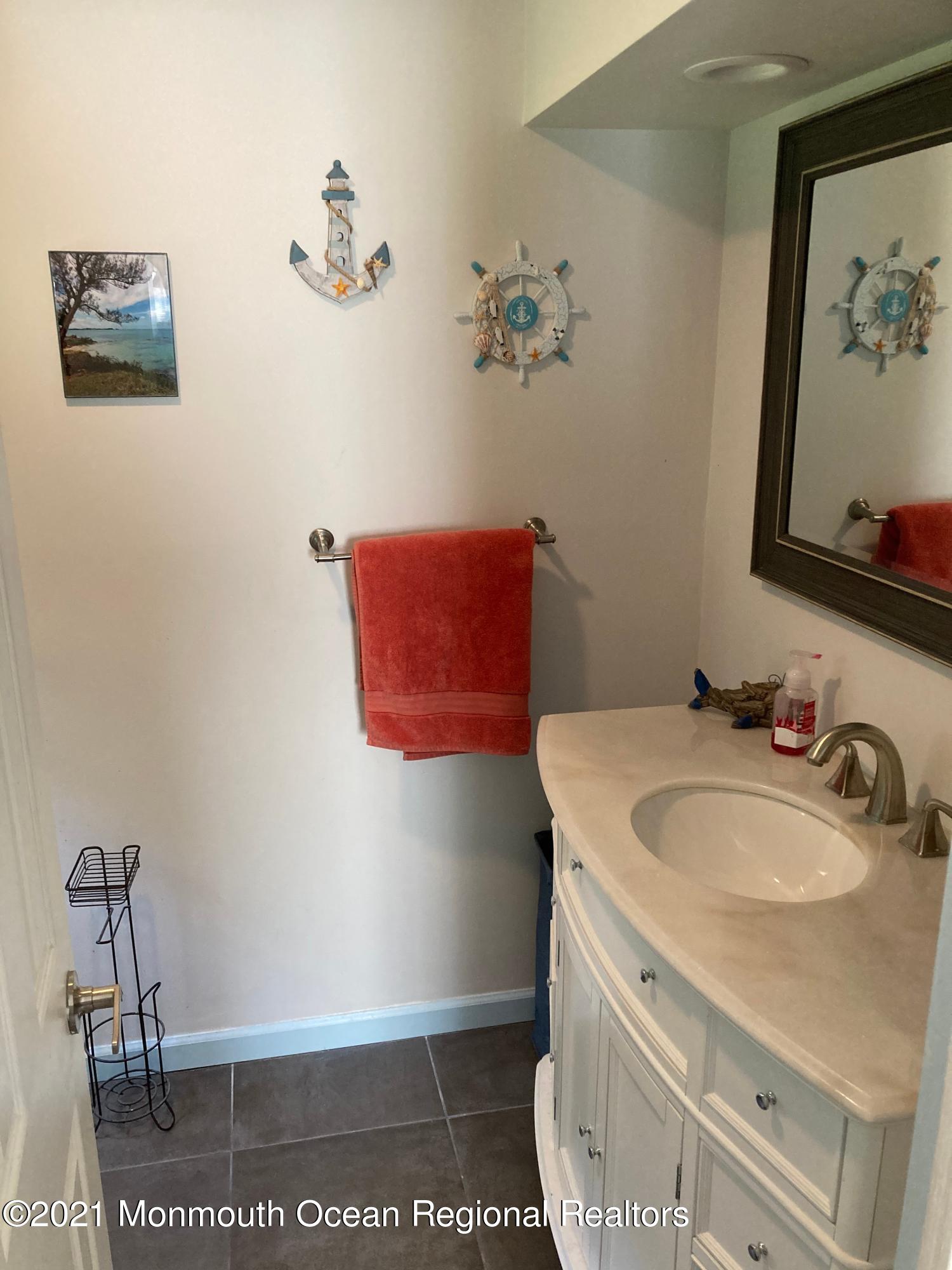 8 Tudor Road Freehold, NJ 07728 - Photo 26 of 46 a bathroom with a sink and a mirror