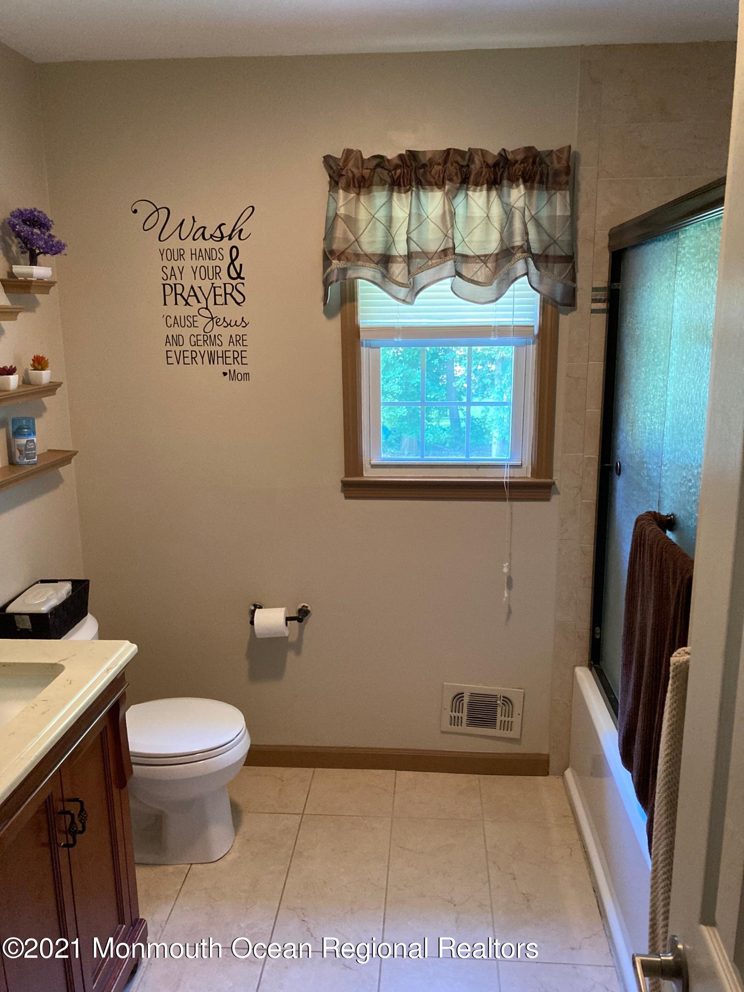 8 Tudor Road Freehold, NJ 07728 - Photo 31 of 46 a bathroom with a toilet and a sink