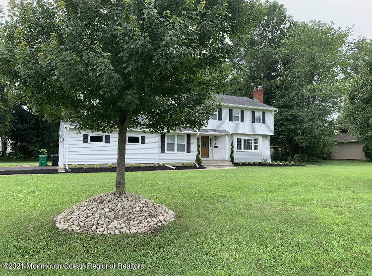 8 Tudor Road Freehold, NJ 07728 - Photo 5 of 46 a front view of a house with a garden