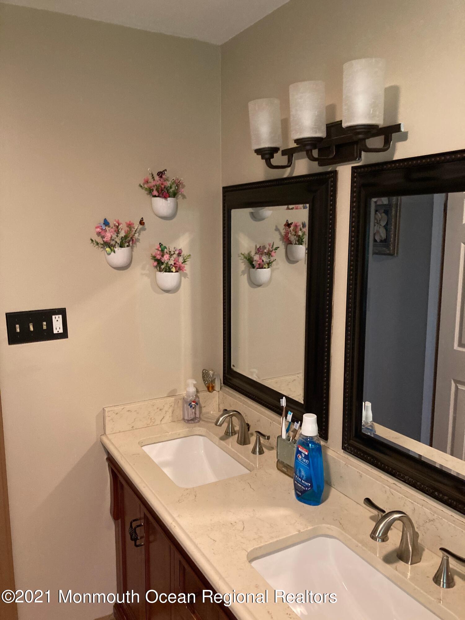8 Tudor Road Freehold, NJ 07728 - Photo 44 of 46 a bathroom with a sink and a mirror