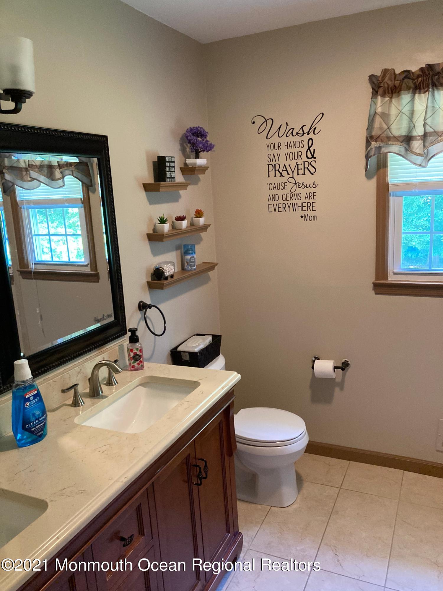 8 Tudor Road Freehold, NJ 07728 - Photo 46 of 46 a bathroom with a sink toilet and mirror