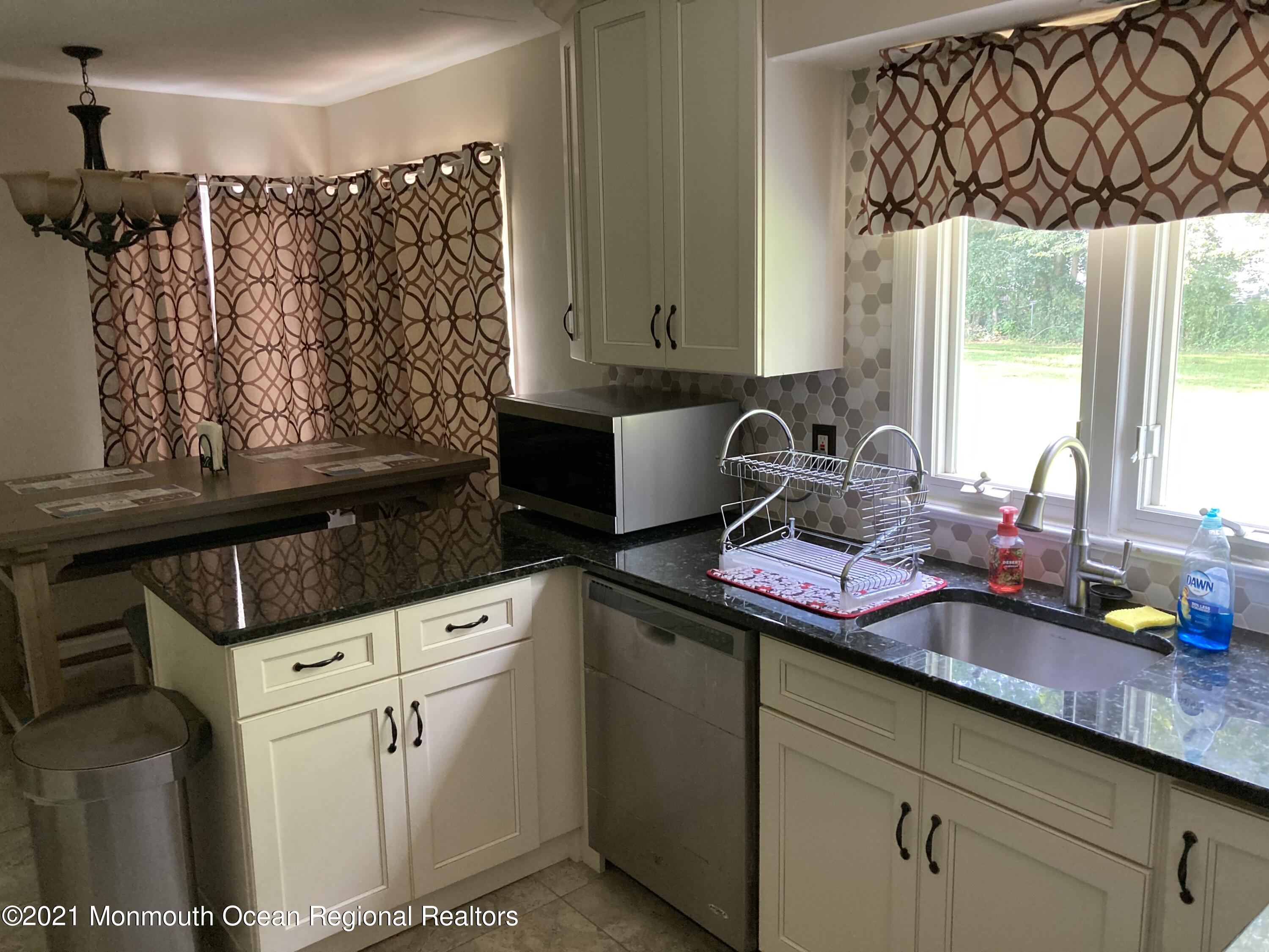 8 Tudor Road Freehold, NJ 07728 - Photo 8 of 46 a kitchen with a sink cabinets and window