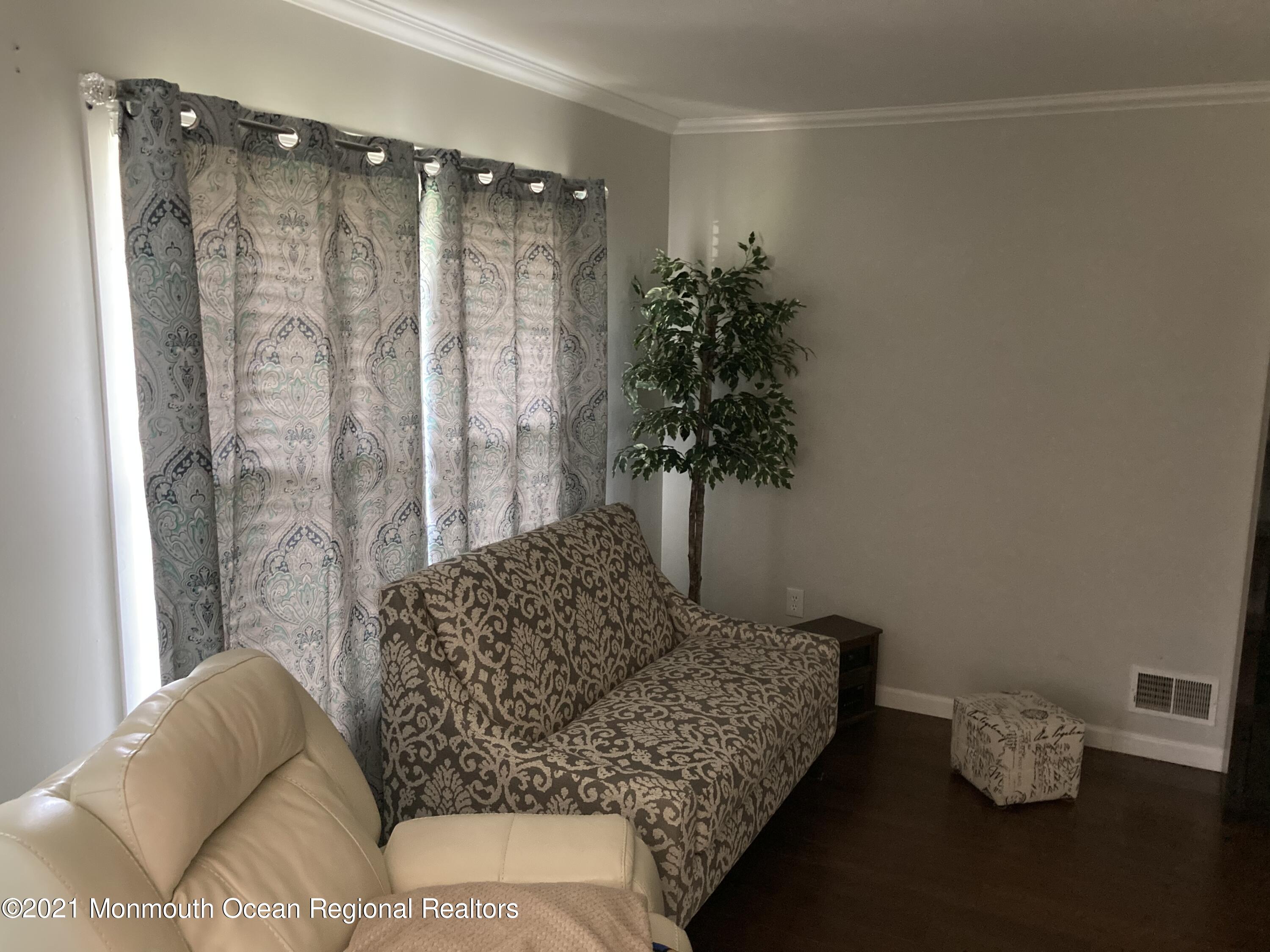 8 Tudor Road Freehold, NJ 07728 - Photo 10 of 46 a living room with furniture and a potted plant