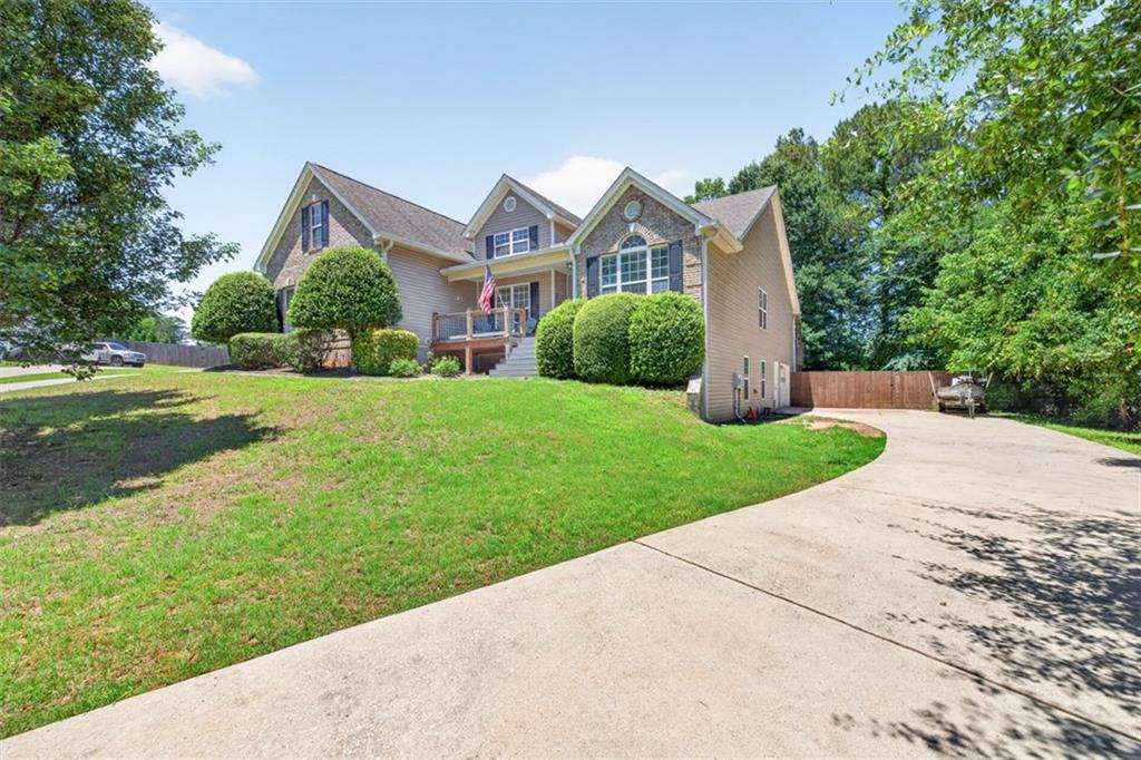89 Katie Spring Lane Jefferson, GA 30549 - Photo 59 of 63 a front view of a house with a yard and garage