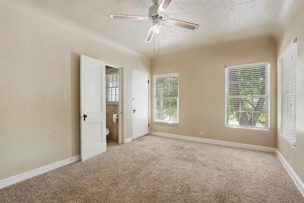 6025 Lewis Street Dallas, TX 75206 - Photo 13 of 37 an empty room with chandelier fan and windows