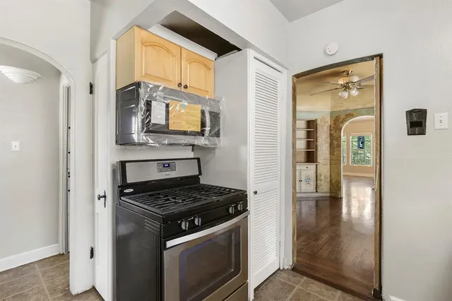 a view of a kitchen with granite countertop cabinets