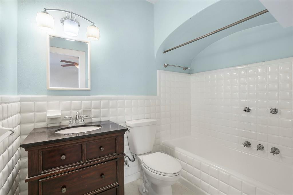 6025 Lewis Street Dallas, TX 75206 - Photo 29 of 37 a bathroom with a sink a toilet and shower