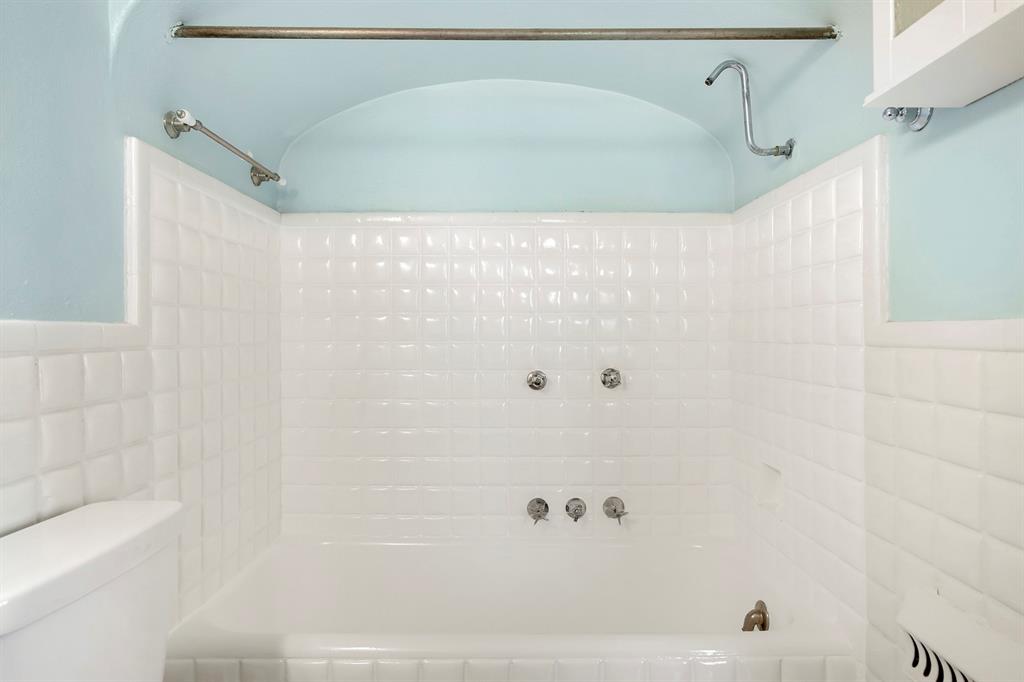 6025 Lewis Street Dallas, TX 75206 - Photo 30 of 37 a bathroom with a shower and a bath tub