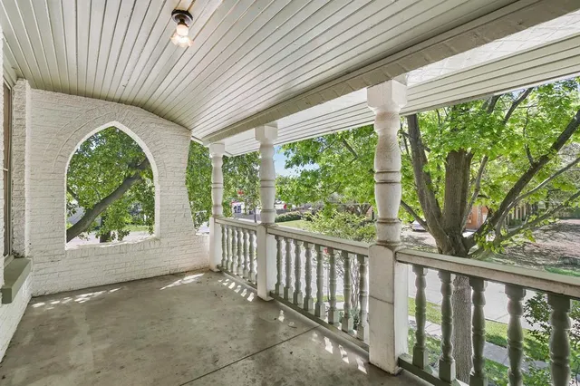 a view of a porch with wooden floor