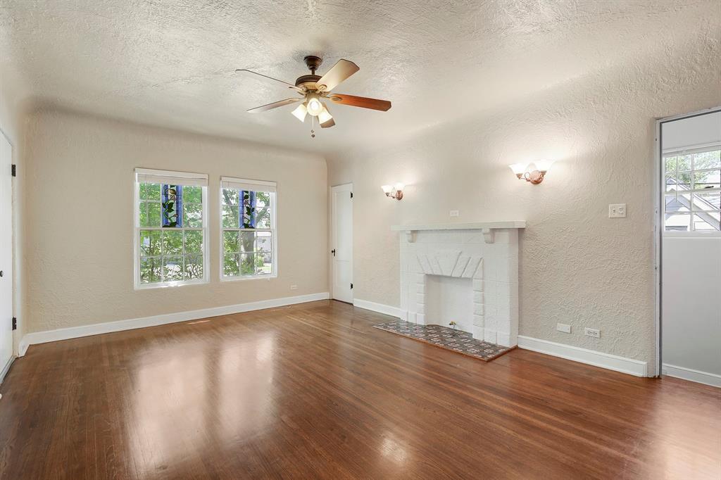 6025 Lewis Street Dallas, TX 75206 - Photo 6 of 37 a view of an empty room with wooden floor and a window